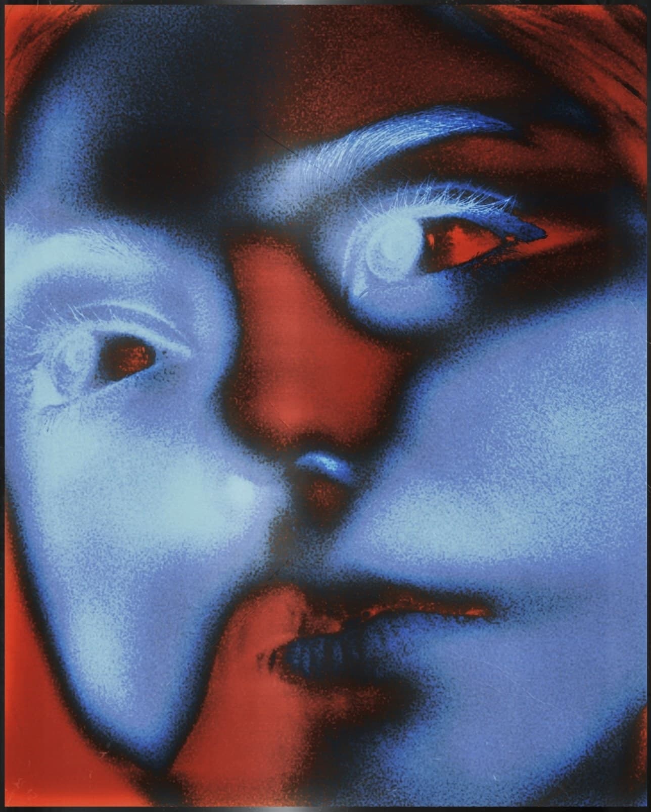 A solarised blue and red close-up of a face in profile, eyes half closed